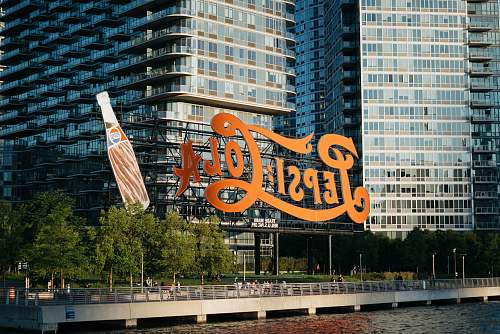 office building Pepsi-Cola signage near body of water city